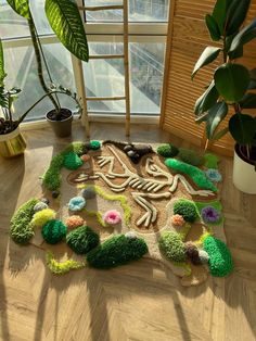 a room with a rug made to look like a skeleton and flowers on the floor