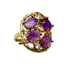 The setting of the ring is designed to accentuate the magnificence of the amethyst stones, allowing them to take center stage. Crafted with precision and attention to detail, the ring showcases the intricate beauty of the stones and enhances their natural radiance.  This statement ring is perfect for those who appreciate bold and distinctive jewelry. Its unique design and vibrant amethyst stones make it a standout piece that adds a touch of elegance and sophistication to any outfit. Amethyst is the birthstone for February. It is believed to have functions that include promoting clarity, intuition, spiritual growth, and emotional balance. Avoid wearing your gemstone jewelry when using cleaning agents or engaging in activities that involve exposure to chemicals. Luxury Purple Multi-stone Rings, Luxury Amethyst Rings With Gemstone Accents, Purple Multi-stone Amethyst Ring Fine Jewelry, Fine Jewelry Purple Amethyst Multi-stone Ring, Purple Multi-stone Amethyst Ring In Fine Jewelry Style, Purple Multi-stone Amethyst Ring, Luxury Amethyst Gemstone Ring, Luxury Amethyst Diamond Ring With Accent Stones, Oval Amethyst Ring In Luxury Style