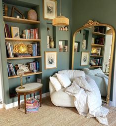 a living room filled with furniture and books