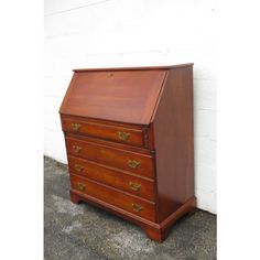 an old wooden desk with three drawers