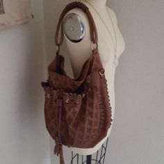 Gorgeous Cognac Leather Hobo Bag With Embroidered Details, Drawstring Tassels & Grommets. Soft & Beautiful. Still Smells Like Leather. Exceptionally Clean In & Out. Some Rub To Leather At Bottom & Handle, But Enhances The Look & Stain At Magnetic Closure Inside, See Pics As Part Of Condition Description. I've Lost Crossbody Strap As Never Used. Beautiful Blue Lining. Made With Such Attention To Detail. Hate To Part & Only Will For Asking. Bag Is Well Worth Asking. Approx Measurements: 15"-18" Ac Brown Embroidered Hobo Shoulder Bag, Embroidered Brown Hobo Shoulder Bag, Embroidered Brown Hobo Tote Bag, Embroidered Brown Tote Hobo Bag, Embroidered Brown Hobo Bag, Designer Brown Hobo Bag With Leather Handles, Daily Use Brown Embroidered Hobo Bag, Everyday Brown Embroidered Bags, Brown Embroidered Everyday Bags