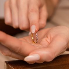 Embrace the elegance of our Amethyst Eternity Ring, a minimalist and dainty piece adorned with enchanting Purple Amethyst gemstones. Perfect for celebrating love, milestones, or adding a pop of color to your stack, this versatile ring is an ideal choice for any occasion. Material: High Quality Solid 925 Sterling Silver Finish: 18K Gold Featuring ~2mm CZ Amethyst Stones on a ~2.8mm Band Model showcases a delicate, everyday layering look featuring our Tia Twisted Ring, Space Birthstone Ring, and L Initial Tag Necklace, Crystal Purple, Sideways Initial Necklace, Dainty Initial Necklace, Twisted Ring, Diamond Huggies, Amethyst Stones, Art Deco Diamond Rings, Twist Ring