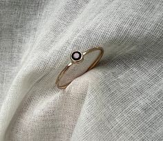 A tiny 3.5mm garnet is set in a 14k gold tube setting on a dainty but strong 14k gold band. Handmade by me! Perfect as a solo birthstone ring, or stacked with other rings. Tube Setting, Stacker Rings, Tiny Rings, Ring Bezel, Style Expert, Birthstone Ring, Gold Band, Stackable Rings, Gold Bands