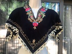 "Look festive in this black floral embroidered shawl!. Condition - looks as if the fringe was cut short - see photo. 18\" length at longest" Fall Folk Embroidered Poncho, Traditional Fringe Poncho One Size, One Size Embroidered Poncho For Festivals, Winter Festival Embroidered Poncho, Embroidered Poncho For Fall, One Size, Embroidered One-size Poncho For Fall, Embroidered One Size Poncho For Fall, One Size Embroidered Poncho For Fall, Traditional Fringed Poncho Shawl