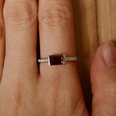 It is a (garnet) ring. The main stone is 5 mm*7 mm emerald cut).weight about 1.30 carats. The basic metal is sterling silver and plated with rhodium/14k white gold/14k rose gold/14k yellow gold You can also go to my shop Home for more elegant rings: https://www.etsy.com/shop/godjewelry?ref=hdr_shop_menu Customization is always welcome and please feel free to contact with me if you have any design ideas! Emerald Cut Sterling Silver Solitaire Birthstone Ring, Emerald Cut Solitaire Birthstone Ring In Sterling Silver, Garnet Emerald Cut Promise Ring, Emerald Cut Ruby Ring Gift, Emerald Cut Garnet Promise Ring, Emerald Cut Garnet Birthstone Jewelry, Classic Emerald Cut Sterling Silver Birthstone Ring, Classic Emerald Cut Birthstone Ring In Sterling Silver, Classic Emerald-cut Birthstone Ring In Sterling Silver