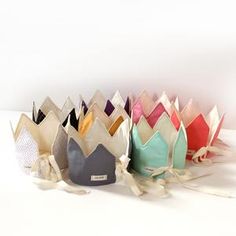 a row of different colored bags sitting on top of a white table next to each other