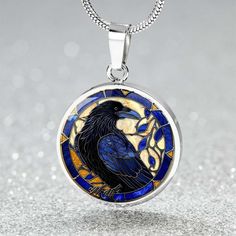 Our gorgeous pendant necklace in a faux stained glass effect makes a perfect  gift for a crow or raven lover. *Engraving option - select engraving option to add a short message on the back. Up to 2 lines of 20 characters including spaces.   Product Dimensions➜ Luxury Necklace: 18-22" (45-56cm) adjustable➜ Circle Pendant: 0.9" x 0.9" (23.5mm x 23.5mm) Our pendants are made of high quality surgical steel with a graphic image that's printed directly onto the steel surface with a bevelled glass coat Crow Pendant Necklace, Crow Or Raven, Raven Ring, Crow Necklace, Crow Pendant, Raven Jewelry, Raven Necklace, Stained Glass Effect, Goth Necklace