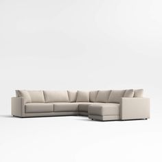 a white sectional couch sitting on top of a white floor