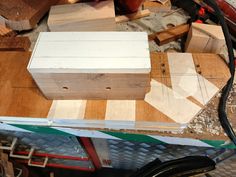 a wooden box sitting on top of a table next to other woodworking supplies and tools