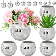 a set of disco ball vases with flowers and succulents