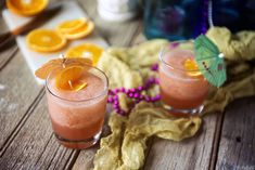 two glasses filled with orange juice and garnish