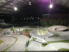 an indoor race track is lit up at night