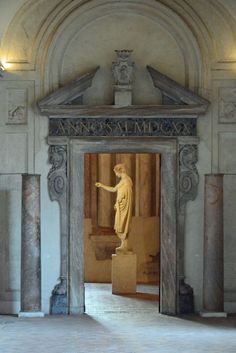 the entrance to an art museum with a statue