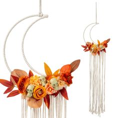 two flowers are attached to the strings of a wind chime with leaves and flowers on them