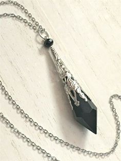 "This handcrafted necklace features a beautiful opaque black glass crystal prism point pendulum, which has been topped with an antique silver toned filigree cap.  Entire pendant measures just under 3\" long. Includes a stainless steel chain (you choose length) w/ lobster claw clasp. Each necklace is individually hand-crafted! Please message me with any questions or special requests. Thanks for visiting!!" Pendulum Necklace, Crystal Pendulum, Crystal Prisms, Necklace Crystal, Handcrafted Necklace, Crystal Necklace Pendant, Large Crystals, Pendant Silver, Silver Filigree