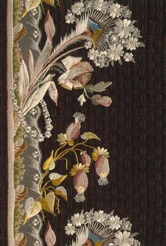 an embroidered wall hanging with flowers and leaves on black fabric, in front of a striped background