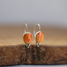 These are wonderful orange, spiny oyster drop earrings. Just that perfect pop of red/orange you want - perfect! This is the Piper Earring design, and we couldn't love it more than in this fabulous, orange Spiny Oyster. Modern and traditional at the same time! Minimal embellishments except for the trio of sterling silver beads - just enough to add mystique to these poppy red Spiny Oyster Shell. All .925 Sterling Silver - oxidized, sanded, and burnished to the perfect finish. Easy on and squeeze a Orange Gemstone Drop Earrings, Orange Gemstone Dangle Earrings, Orange Teardrop Gemstone Earrings, Unique Orange Round Earrings, Orange Teardrop Sterling Silver Earrings, Coral Earrings With Ear Wire As Gift, Orange Teardrop Jewelry With Matching Earrings, Coral Earrings For Gift, Unique Orange Teardrop Jewelry