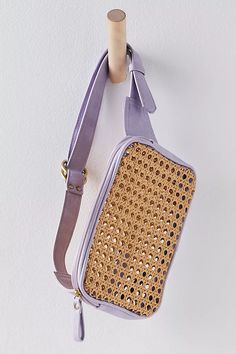 a purple purse hanging on the wall