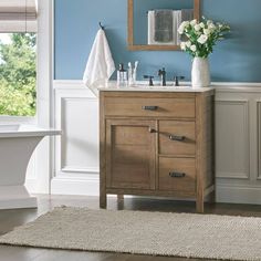 a bathroom with blue walls and white fixtures