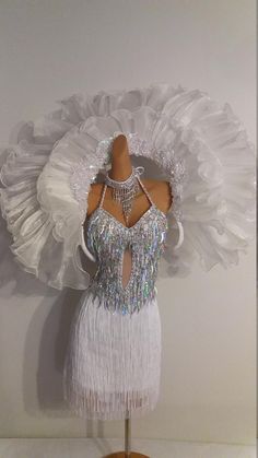 a mannequin dressed in white and silver clothing