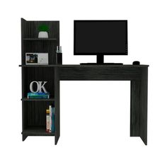 a computer desk with a monitor and bookshelf