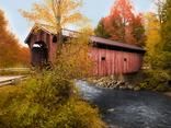 a red covered bridge over a river surrounded by trees