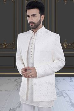 This men's sherwani, featuring elegant sequin and thread work, will elevate any occasion with its open jacket design. The intricate detailing adds a touch of luxury and sophistication. Made with high-quality materials, it is sure to impress with its stunning craftsmanship and modern yet traditional design. Elegant Sherwani With Intricate Embroidery For Diwali, Elegant Ceremonial Sets With Chikankari Embroidery, Elegant Festive Bandhgala With Zari Work, Designer Formal Nehru Jacket With Dabka Work, Designer Nehru Jacket With Dabka Work For Formal Events, Designer Nehru Jacket With Dabka Work For Formal Occasions, Elegant Bandhgala With Dabka Work For Festive Occasions, Elegant Sherwani With Chikankari Embroidery In Traditional Drape, Elegant Sherwani With Chikankari Embroidery