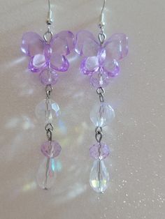 These cute handmade butterfly earrings are a little over 3 inches. Light purple acrylic butterflies are accented with purple and clear AB glass beads. The ear wires are easily adjustable :) Purple Fairycore, Fairycore Earrings, Simplistic Jewelry, Purple Heart Earrings, Beautiful Beaded Earring, Kawaii School, Fantasy Earrings, Handmade Butterfly, Purple Acrylic