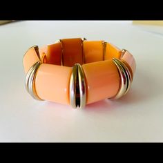 *Bold, Chunky Vintage Bakelite Bracelet *This Link Stretch Bracelet Is Made Of Eight Cantaloupe "Melon" Color Bakelite Wedges Separated By Gold Tone Folded Button Links. *Each Wedge Is .75" Long And 1" Wide. *Newly Strung On Goldenrod Elastic Cord With Plenty Of Stretch To Fit Up To Medium-Sized Wrist *Clean; Simichrome Polish-Tested, Excellent Vintage Condition Modern Orange Bangle Bracelets, Orange Bracelet For Formal Occasions, Formal Orange Bracelet Jewelry, Formal Orange Bracelet, Orange Bangle Stretch Bracelet For Gift, Elegant Orange Bangle Jewelry, Modern Orange Adjustable Bracelets, Adjustable Orange Stretch Bracelet, Bakelite Bracelets