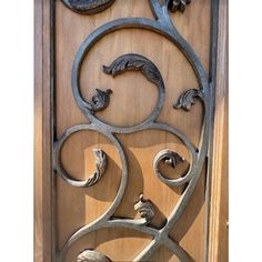 an ornate wooden door with wrought iron work on the front and side panels, depicting animals