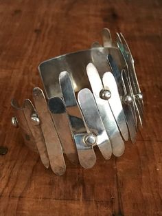 You will love the way this fabulously unique cuff dresses up your wrist! The inside of this bracelet is a smooth silver band and the outside looks like it's had strips of silver hammered on. This looks like an artisan piece to me. The silver strips are anywhere from 1/2" to 1 1/2" long. Please bear in mind that silver is a fairly soft metal, and some of the strips are a bit bent in some areas, but I believe it takes away from the general look of the cuff. Please see all photos for details.I offe Filigree Diamond Ring, Heart Shaped Frame, Jewelry Antique, Gold Snake, Gold Filigree, Hammered Silver, Silver Band, Vintage Sterling Silver, Sterling Silver Bracelets