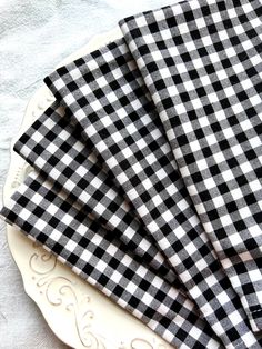 three black and white checkered napkins on a plate