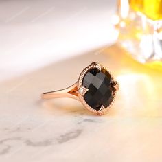 a black diamond ring sitting on top of a table