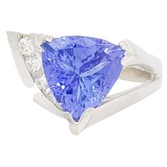 Beautiful 4.00 ct. tanzanite trillion with 0.15 ct. good quality white diamond rounds. Handmade in 14k white gold. Ring size 9.5. Formal Tanzanite Trillion Cut Ring, Classic Tanzanite Jewelry In Trillion Cut, Trillion Cut Tanzanite Jewelry In White Gold, Trillion Cut Tanzanite White Gold Jewelry, Tanzanite Trillion Cut Ring For Anniversary, Trillion Cut Tanzanite Ring For Anniversary, Elegant Tanzanite Trillion Cut Rings, Trillion Cut Sapphire Jewelry, Tanzanite And Diamond Ring