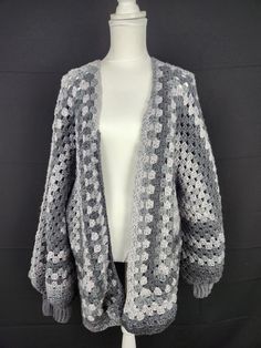 Wrap yourself in cozy comfort with our handmade Granny Square Cardigan. This versatile and stylish piece is crafted with love and features a beautiful crochet design that adds a touch of charm to any outfit. Stay warm and fashionable this season - get your Granny Square Cardigan today! Dimensions: Shoulder to Waist- 33' Cuff to Shoulder- 27' Back Panel- 22' 1/2 Front Panel- 11' Yarn: Red Heart Ombre Grey Granny Square Cardigan, Square Cardigan, Crochet Design, Red Heart Yarn, Yarn Sizes, Comforters Cozy, Beautiful Crochet, Crochet Designs, Granny Square