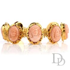 This delicate and intricate vintage coral bracelet was crafted in 18K yellow gold. Featuring 8 carved coral Cameos bezel set, each measuring appx. 14.50mm x 19.50mm.Each cameo face is unique and all are hinged between and set in an intricately carved link.Measuring appx. 24.38mm x 7.25 Inch, this soft pinkish colored coral cameo bracelet will enhance any attire.Stamped with purity mark.Remains in Excellent Condition.Accompanied by a professional appraisal document. Luxury Carved Jewelry For Formal Occasions, Formal Coral Jewelry With Cabochon Details, Formal Coral Jewelry With Cabochon, Luxury Round Coral Jewelry, Luxury Coral Jewelry For Formal Occasions, Yellow Gold Intaglio Bracelet For Formal Occasions, Formal Yellow Gold Intaglio Bracelets, Formal Yellow Gold Intaglio Bracelet, Luxury Carved Bracelet Jewelry