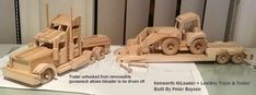 three wooden toy trucks are sitting on a table