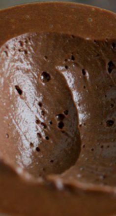 a close up of a chocolate cake batter in a bowl