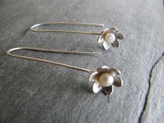 "These long earrings are made with a little white pearl sitting in the center of a flower at the end of a long handmade wire. Flower measures 10mm across 1 3/4\" long Simple and pretty." Sterling Silver Flower Earrings With Pearl Drop, Fold Forming, Metal Ideas, Hardware Jewelry, Long Flowers, Wire Rings, Handmade Wire, Wire Work, White Pearl