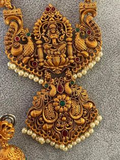 A beautiful necklace with gold-colored earrings with the wonderful Goddess Lakshmi Decorated with green and pink crystals and pearls. An unusual chain made of flowers and peacocks. Traditional Indian yumka earrings with flowers and earwires. Necklace 48 cm long, medallion 8 cm x 11 cm. Earrings 4.5 cm long, yumka diameter 2 cm. Gold Kundan Peacock Pendant Necklace, Temple Jewelry For Puja With Jeweled Details, Temple Jewelry Jeweled For Puja, Gold Jewelry Sets With Peacock Design For Festivals, Gold Jewelry With Peacock Design For Festivals, Spiritual Wedding Jewelry With Peacock Design, Gold Chandbali Jeweled Necklaces, Green Jewelry With Intricate Design For Puja, Green Intricate Design Jewelry For Puja