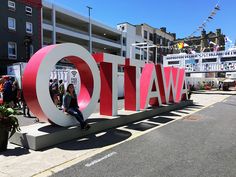 a woman sitting on the letters that spell out ottawa