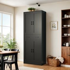 a tall cabinet in the corner of a dining room with wooden floors and white walls