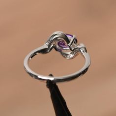 It is a natural amethyst ring. The main stone is 5mm*7mm oval cut, weight about 0.76 carats. The basic metal is sterling silver and plated with rhodium. To change the metal to a solid gold (white/rose) or platinum is also available, please ask for a quotation if you want. You can also go to my shop Home for more elegant rings: https://www.etsy.com/shop/godjewelry?ref=hdr_shop_menu More amethyst rings: https://www.etsy.com/shop/godjewelry?ref=seller-platform-mcnav&section_id=20709248 Customiz Oval Amethyst Ring With Prong Setting In Cubic Zirconia, Oval Amethyst Ring With Cubic Zirconia In Prong Setting, Oval Amethyst Ring With Cubic Zirconia Accent Stones, Oval Amethyst Ring With Cubic Zirconia For Promise, Oval Amethyst Cubic Zirconia Promise Ring, Purple Amethyst Oval Diamond Ring, Purple Topaz Promise Ring, White Gold Amethyst Birthstone Ring, Elegant Purple Birthstone Ring With Open Design