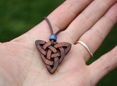 "This beautiful and unique hand-carved Triquetra pendant will be made for you, or a loved one, in my studio on the West of Ireland. This delicately carved Celtic knot features a piece of rosewood, recycled from musical instruments constructed by a local luthier. As a musician myself, I take enormous satisfaction in creating a piece of jewellery whose inherent wood has previously featured in a beautiful hand-made guitar! Celtic knots date back to the 3rd to 4th century B.C. They were used to symb Symbolic Carved Brown Jewelry, Traditional Mahogany Jewelry As Gift, Traditional Mahogany Jewelry For Gifts, Brown Carved Spiritual Jewelry, Spiritual Brown Carved Jewelry, Traditional Handmade Mahogany Jewelry, Unique Mahogany Jewelry For Gift, Carved Brown Jewelry For Gifts, Brown Carved Jewelry Gift