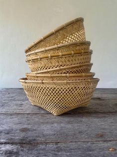 four woven baskets stacked on top of each other