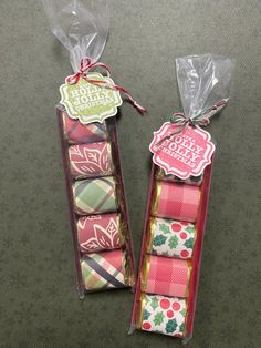 two packages of candy wrapped in cellophane and tied with ribbon on the floor