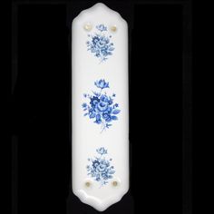 a white and blue vase with flowers on it