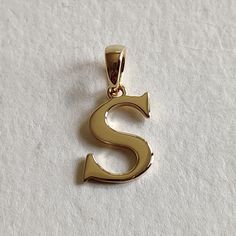 This is an exquisite initial charm pendant set in 14K Solid Gold.  An elegant design, perfect for any occassion. ITEM DETAILS: ✓ Letter : S ✓ Gold Kt: Solid 14K Yellow Gold ✓ 14 K Gold Weight : 1.08 grams ✓ Gross Weight: 1.08 grams >>The Gold purity is guaranteed and it comes with authentic 14K gold hallmark. >>A-Z letters available on my Etsy Shop. CUSTOMER SUPPORT: We are available 24/7 to respond to all your queries! PACKAGING: The pendant comes in layers of safe and secure wrapping along with a free Handmade Jewelry Box. S Pendant Letter Gold, Elegant Hallmarked Initial Necklace For Anniversary, Classic Formal Initial Necklace, Elegant Hallmarked Initial Pendant Necklace, Elegant Round Initial Necklace, Elegant Hallmarked Initial Necklace, Yellow Gold Initial Necklace With Polished Finish, Personalized Luxury Initial Necklace For Anniversary, Luxury Personalized Initial Necklace For Anniversary