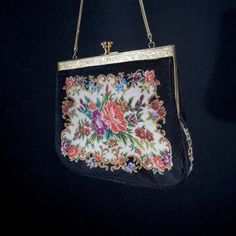 A small ladies handbag vintage handmade. Fine example of a cosy lady's handbag of the beginning of the last century. Hand embroidered fabric. Metal clasp and black satin inside. Look at those small representations of flowers on the front and back of the bag. Lovingly made. Vintage. Size  W 18 H 17 cm. It has been around for a long time but just a tiny bit of wear. Still beautiful and surely wearable. Please have a look at all our vintage handbags in the  - Ladies Handbags - or the - Ladies first Vintage Embroidered Handheld Shoulder Bag, Vintage Tapestry Bags For Gifts, Vintage Formal Bag With Floral Embroidery, Vintage Embroidered Clutch Evening Bag, Vintage Floral Embroidery Bags For Formal Occasions, Vintage Floral Embroidered Bag For Formal Occasions, Vintage Floral Embroidery Formal Bags, Handmade Tapestry Bags For Evening, Antique Tapestry Evening Bag