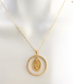 Our lady of Guadalupe necklace Beautiful and dainty 18k Gold Plated Guadalupe necklace. Perfect gift for moms, grandmas, aunts, sisters and why not yourself?! MATERIAL AND SIZE 18k gold plated medal 18k gold filled cable chain Cubic zirconia Size pendant: 2.4cm Length chain: you choose it If you have questions about the product, feel free to reach me out. Don't forget to check out my other items in the store: Https://www.etsy.com/shop/nyahwithlove Miraculous Medal Pendant Jewelry For Wedding, Miraculous Medal Wedding Pendant Jewelry, Wedding Miraculous Medal Pendant Jewelry, Spiritual Yellow Gold Our Lady Of Guadalupe Jewelry, Gold Virgin Mary Medallion Jewelry, Gold Our Lady Of Guadalupe Round Pendant Necklace, Spiritual Jewelry: Our Lady Of Guadalupe Round Pendant, Lady Of Guadalupe Necklace, Scapular Necklace